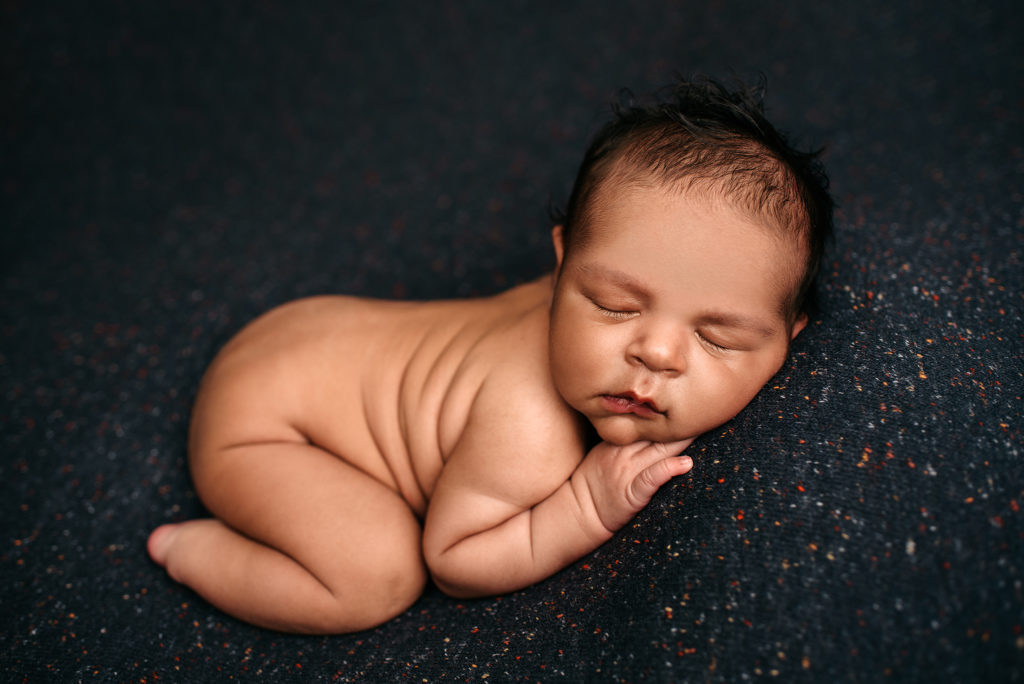 Newborn boy on blue speckled backdrop in Jacksonville, FL