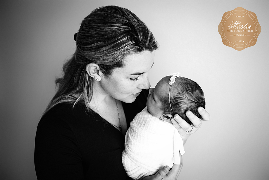 Black and white photo of mom holding newborn girl in St. Johns, FL.